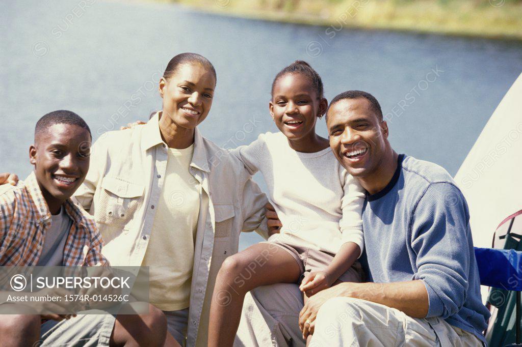 Stock Photo: 1574R-014526C Portrait of parents sitting at a campsite with their son and daughter
