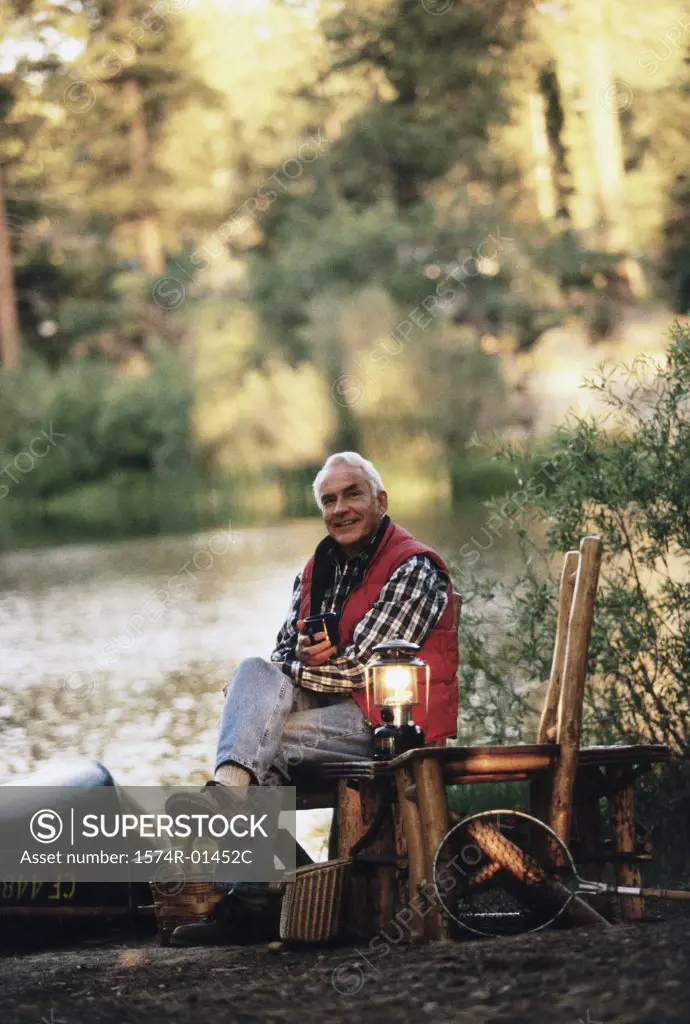 Portrait of a senior man sitting outdoors on a chair