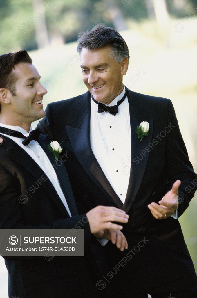 Stock Photo: 1574R-014530B Young man talking to a mid adult man