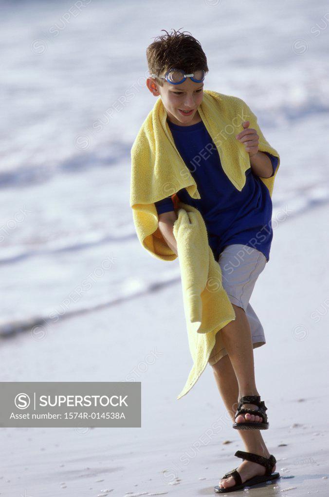 Stock Photo: 1574R-014538A Boy stepping on the beach