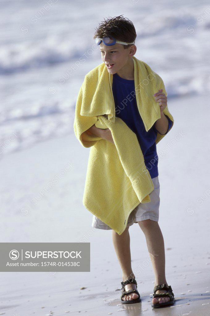 Stock Photo: 1574R-014538C Boy walking on the beach
