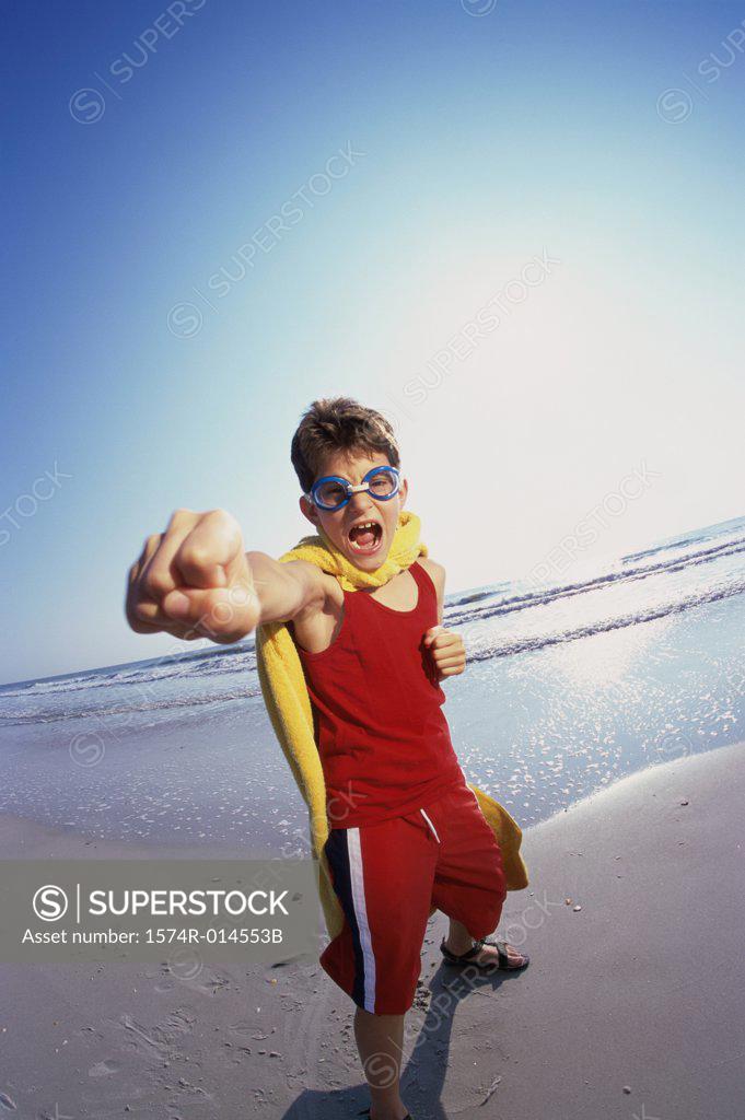Stock Photo: 1574R-014553B Portrait of a boy punching on the beach