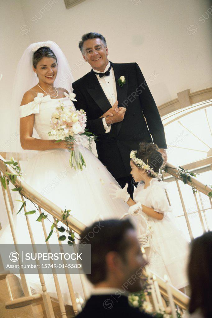 Stock Photo: 1574R-014558D Bride walking down stairs with her father