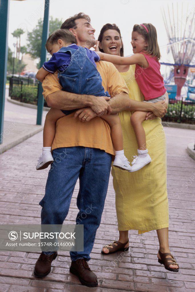 Stock Photo: 1574R-014600A Parents carrying their son and daughter