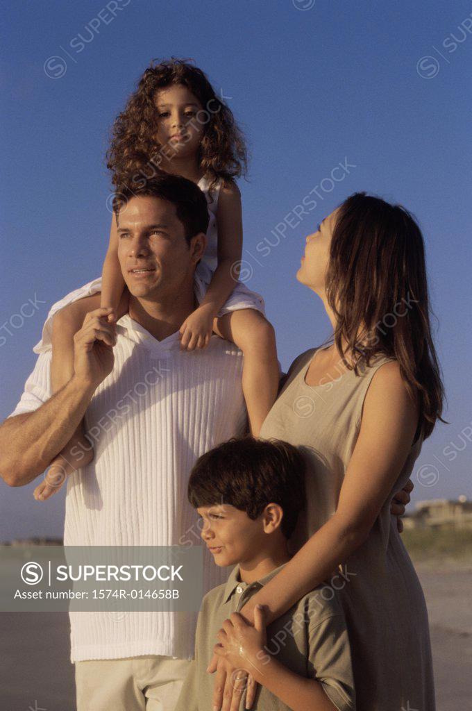 Stock Photo: 1574R-014658B Close-up of parents and their two children standing on the beach