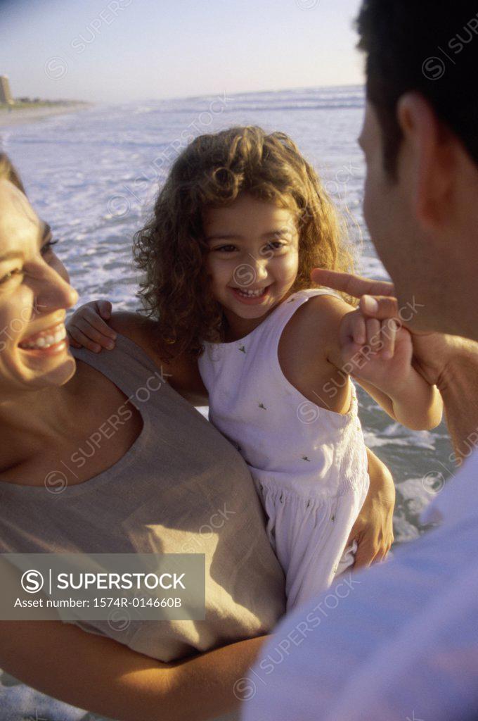 Stock Photo: 1574R-014660B Young couple on the beach with their daughter