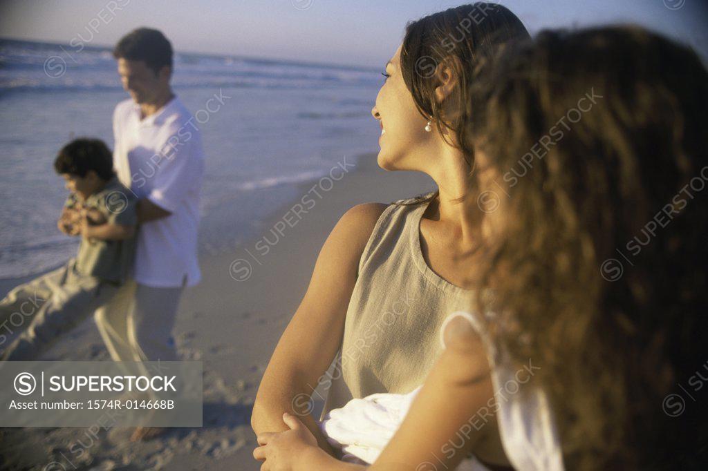 Stock Photo: 1574R-014668B Young couple on the beach with their son and daughter