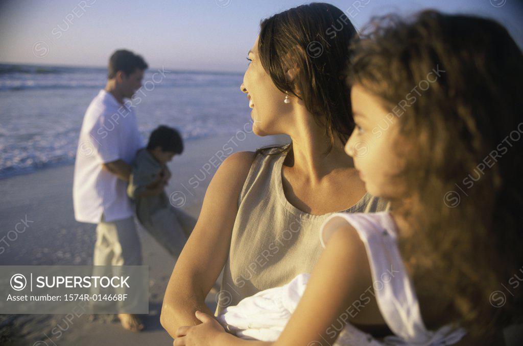 Stock Photo: 1574R-014668F Young couple on the beach with their son and daughter