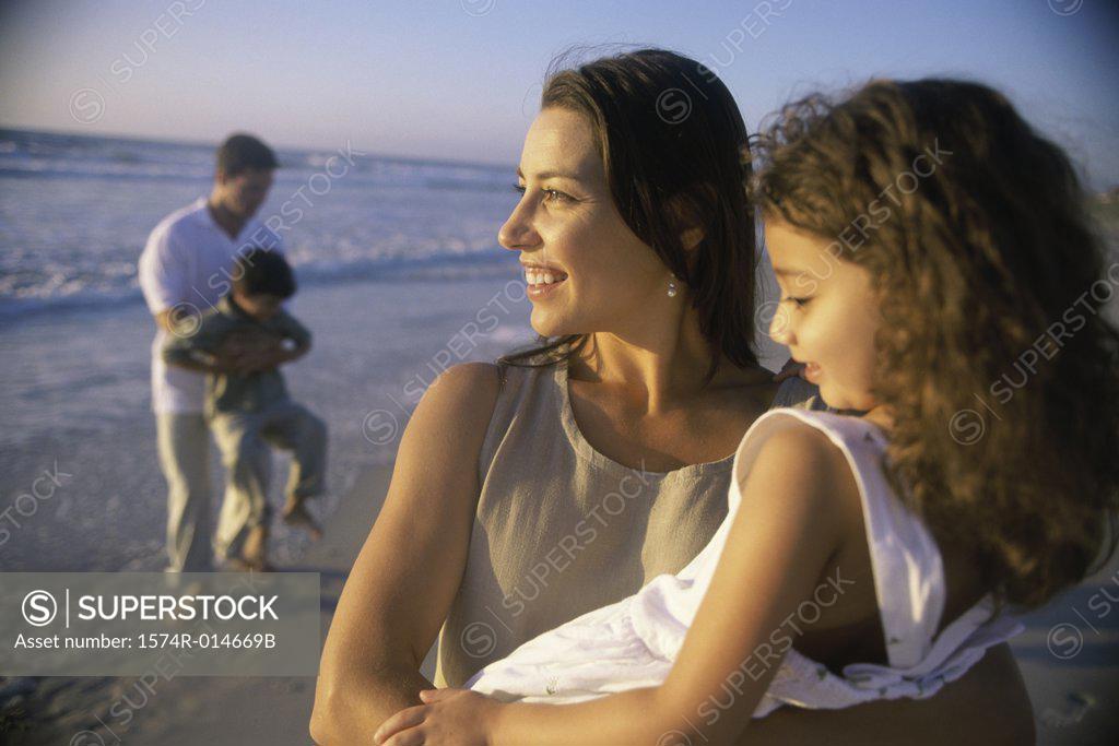 Stock Photo: 1574R-014669B Young couple on the beach with their son and daughter