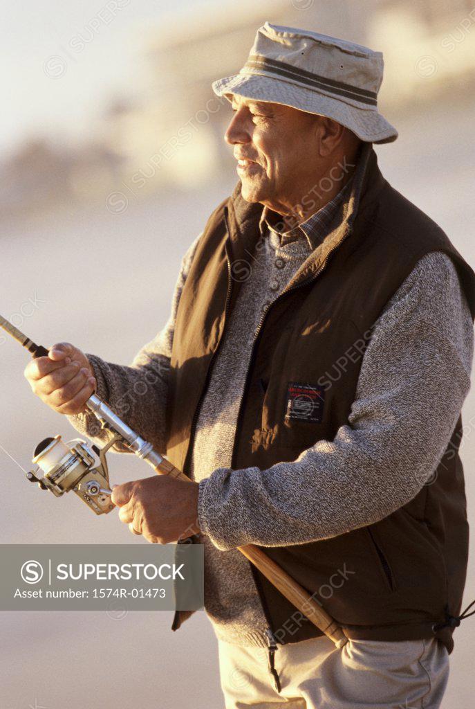 Stock Photo: 1574R-01473 Senior man holding a fishing rod