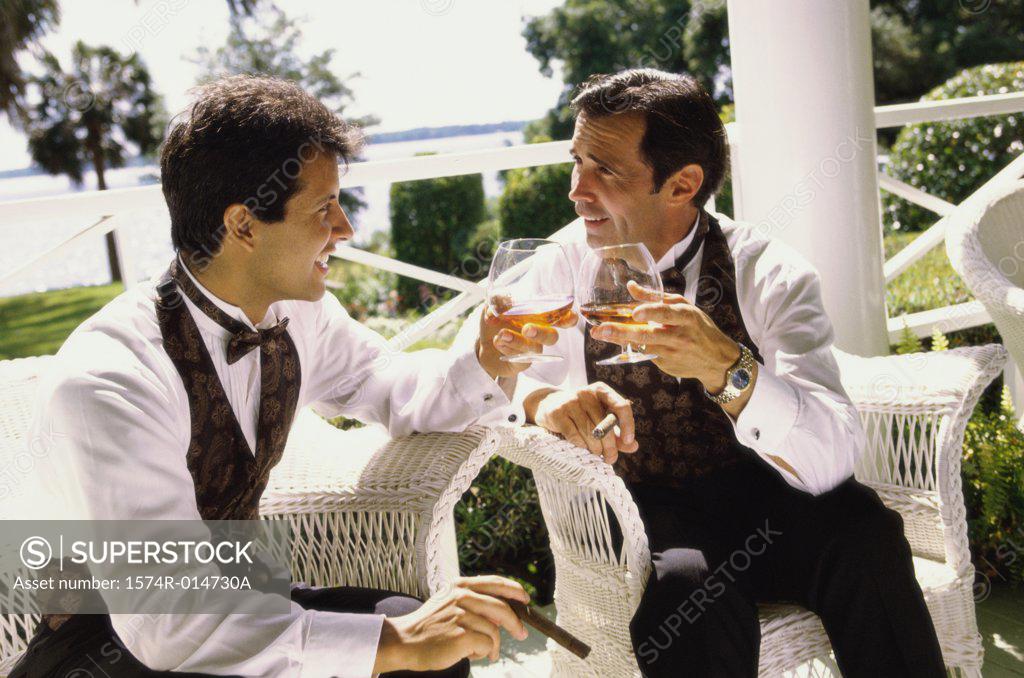 Stock Photo: 1574R-014730A Father and his son toasting with wine