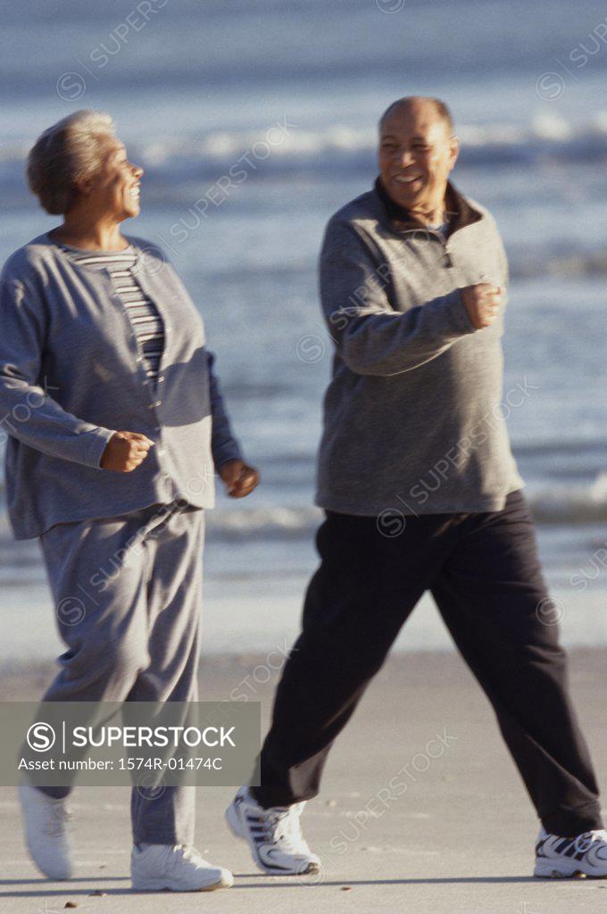 Stock Photo: 1574R-01474C Senior couple walking at the beach