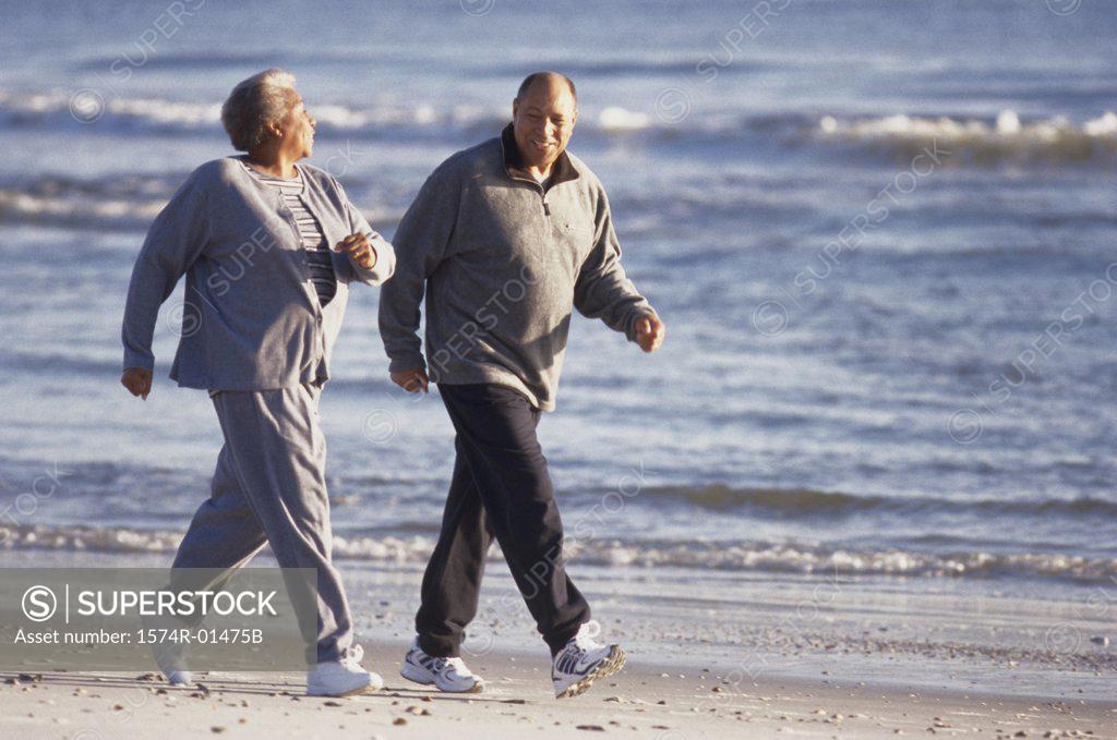 Stock Photo: 1574R-01475B Senior couple walking at the beach