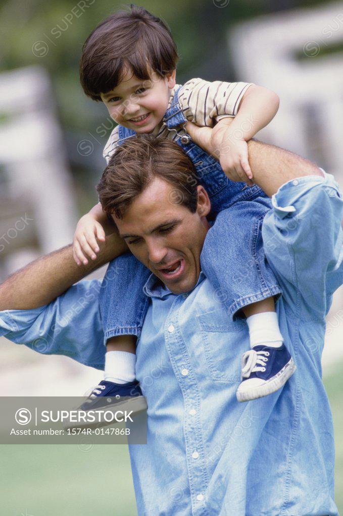 Stock Photo: 1574R-014786B Father carrying his daughter on his shoulders