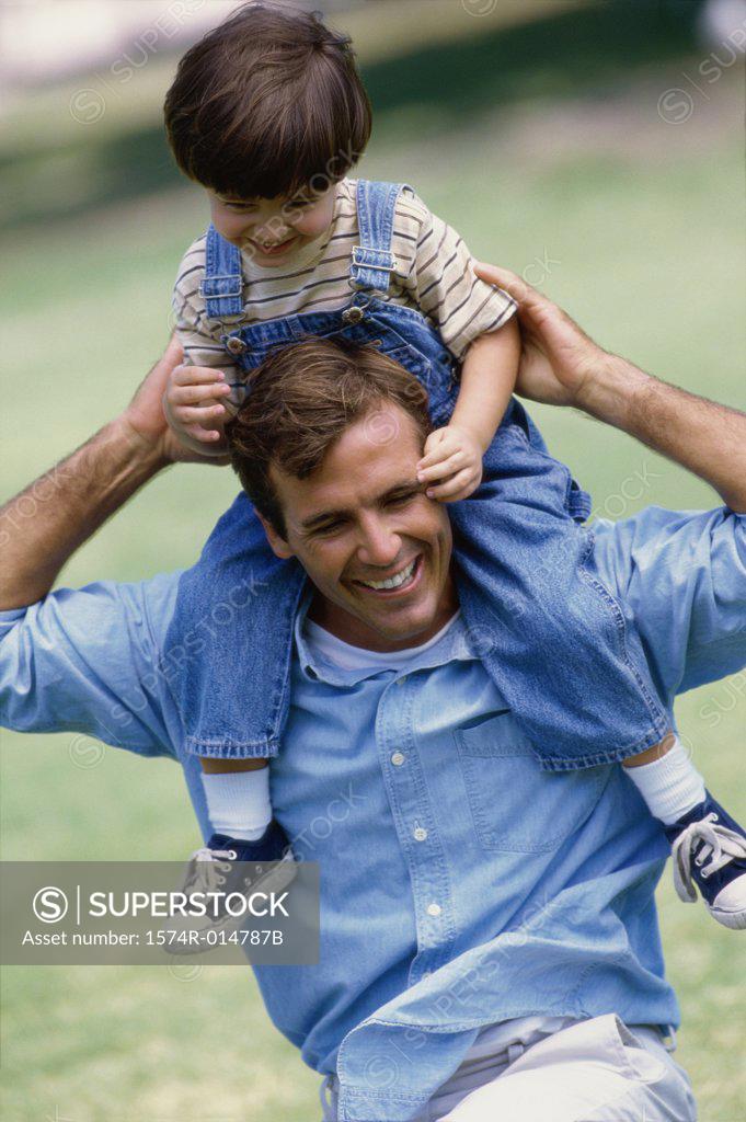 Stock Photo: 1574R-014787B Father carrying his daughter on his shoulders