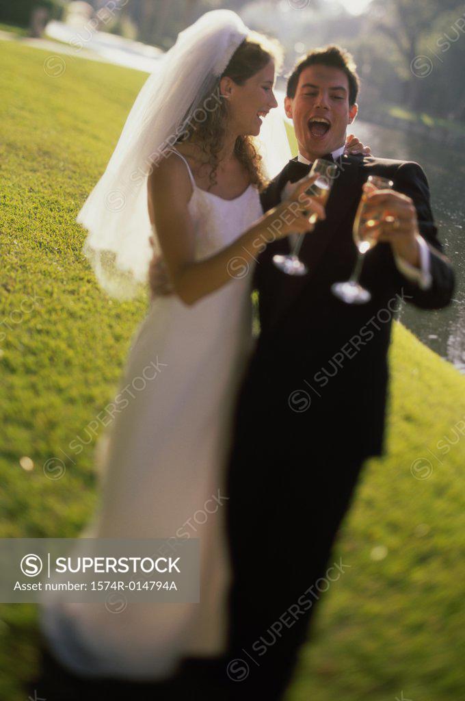 Stock Photo: 1574R-014794A Newlywed couple toasting with champagne