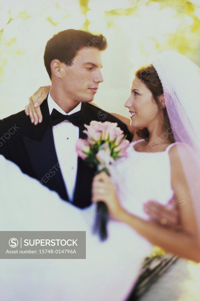 Stock Photo: 1574R-014796A Close-up of a groom carrying his bride