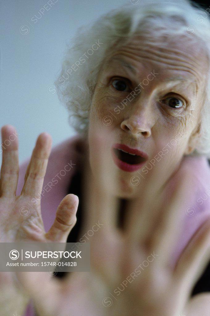 Stock Photo: 1574R-01482B Portrait of a senior woman holding her hands out