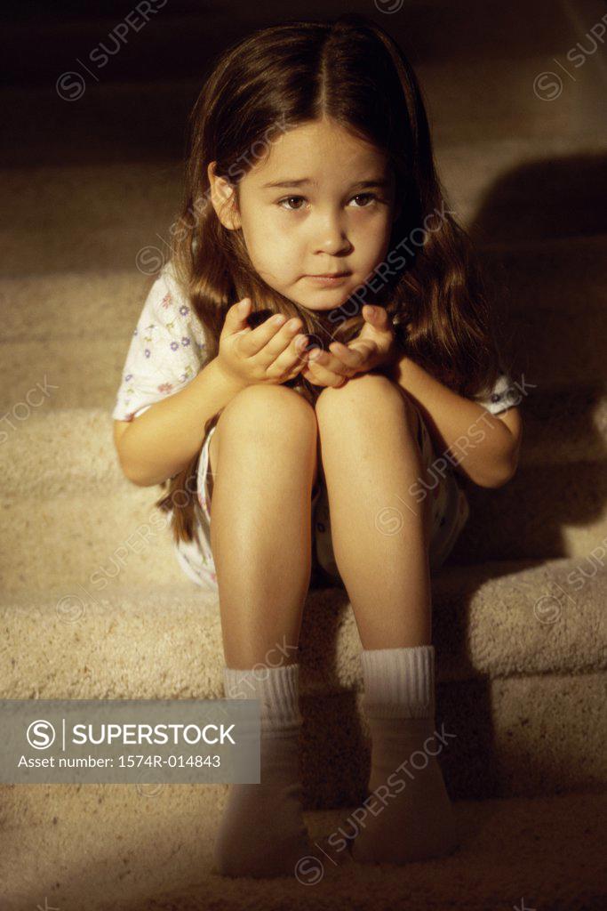 Stock Photo: 1574R-014843 Close-up of a girl sitting on steps
