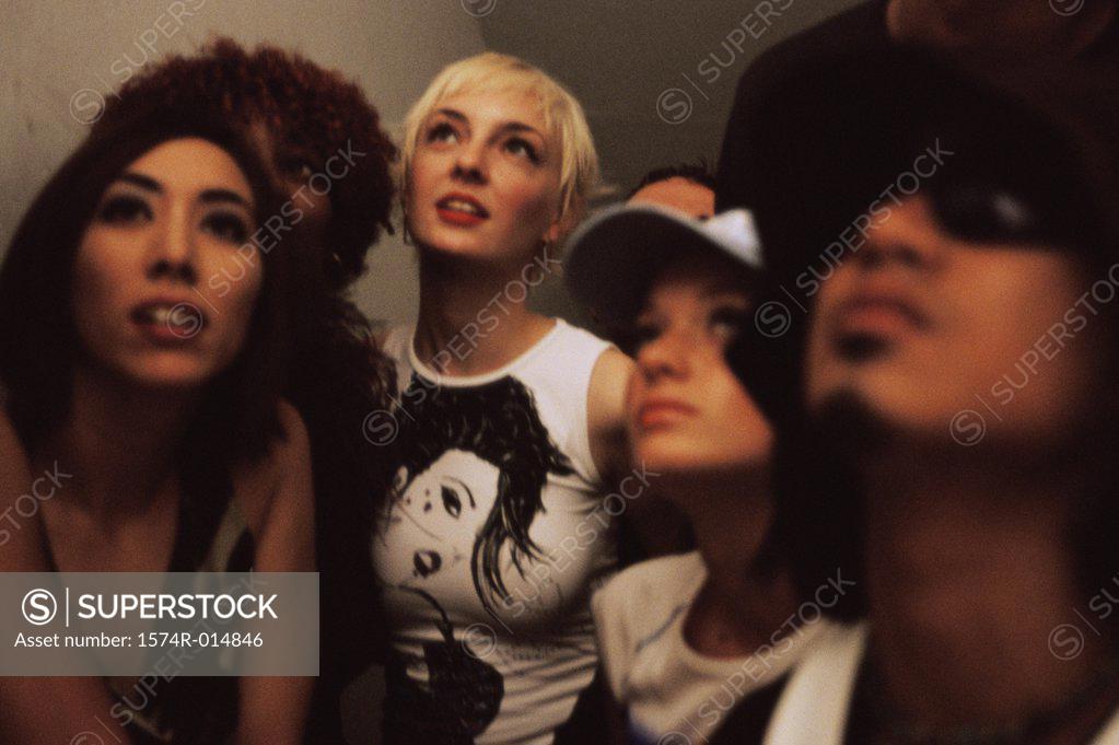 Stock Photo: 1574R-014846 Close-up of four young women and a young man looking up