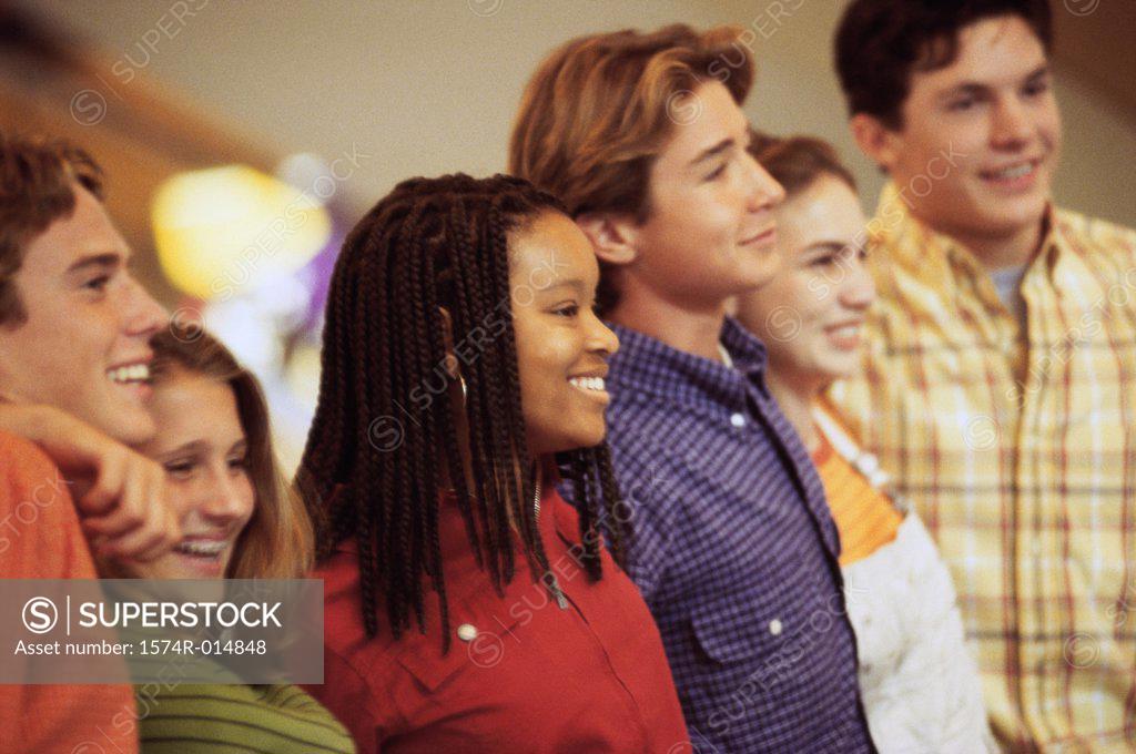 Stock Photo: 1574R-014848 Side profile of a group of teenagers standing in a row