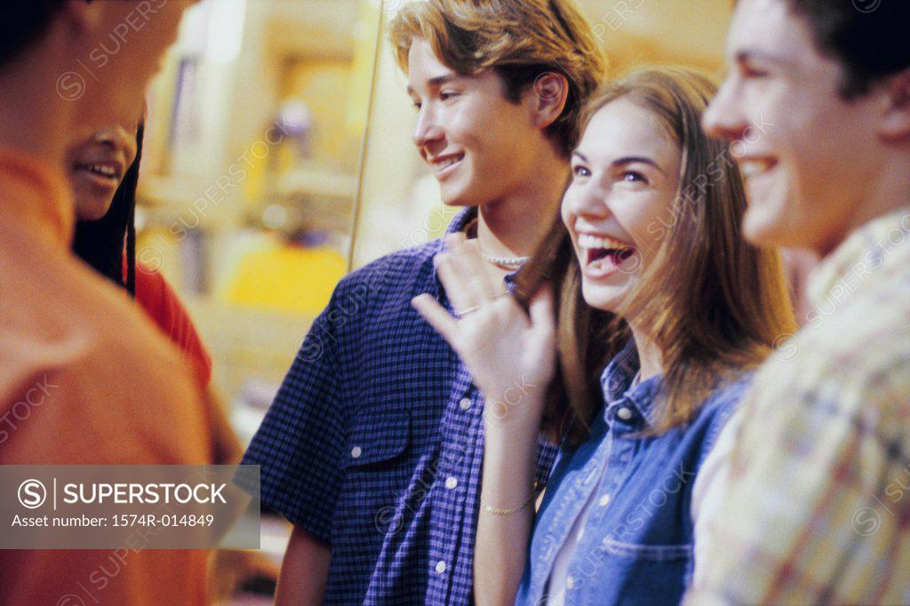 Stock Photo: 1574R-014849 Two teenage girls and three teenage boys talking to each other