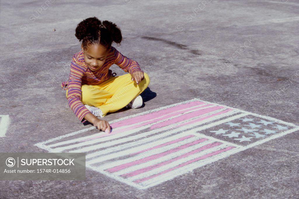 Stock Photo: 1574R-014856 High angle view of a girl drawing an American flag on the ground with chalk