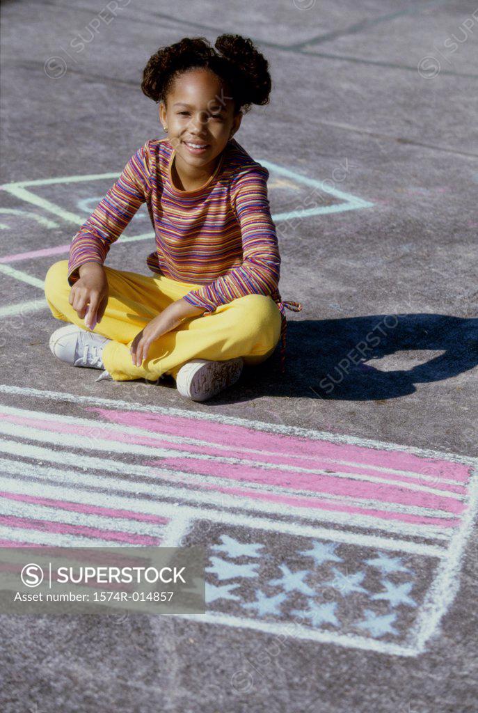 Stock Photo: 1574R-014857 Portrait of a girl drawing an American flag on the ground with chalk