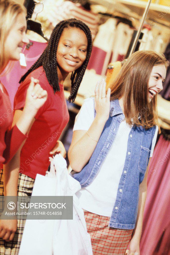 Stock Photo: 1574R-014858 Three teenage girls standing in a shopping mall