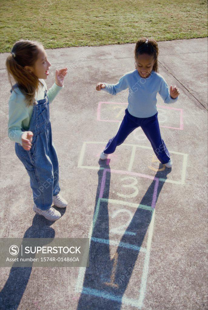 Stock Photo: 1574R-014860A High angle view of two girls playing hopscotch