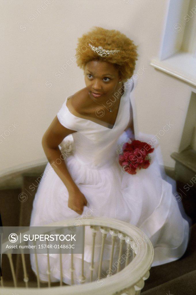 Stock Photo: 1574R-014863C High angle view of a newlywed woman walking up stairs