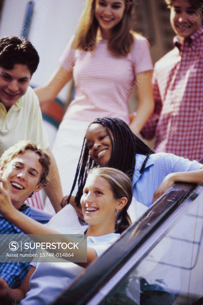 Stock Photo: 1574R-014864 Group of teenagers standing on an escalator
