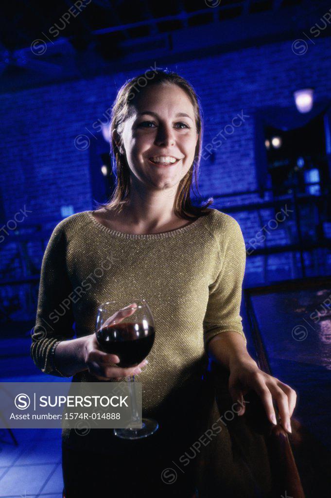 Stock Photo: 1574R-014888 Close-up of a young woman holding a glass of red wine