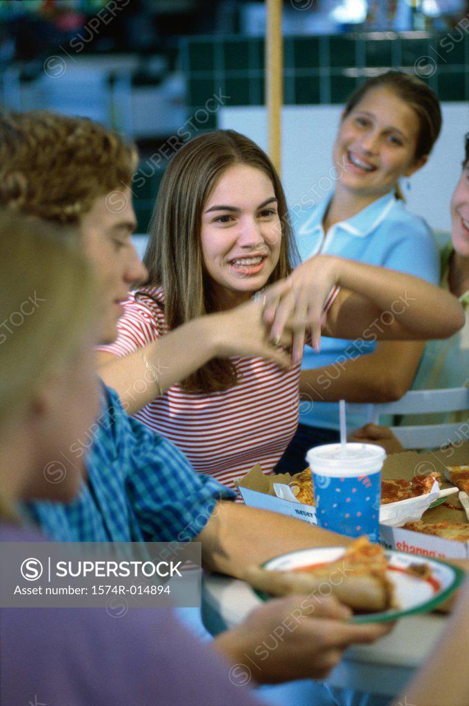 Stock Photo: 1574R-014894 Three teenage girls and a teenage boy smiling in a restaurant