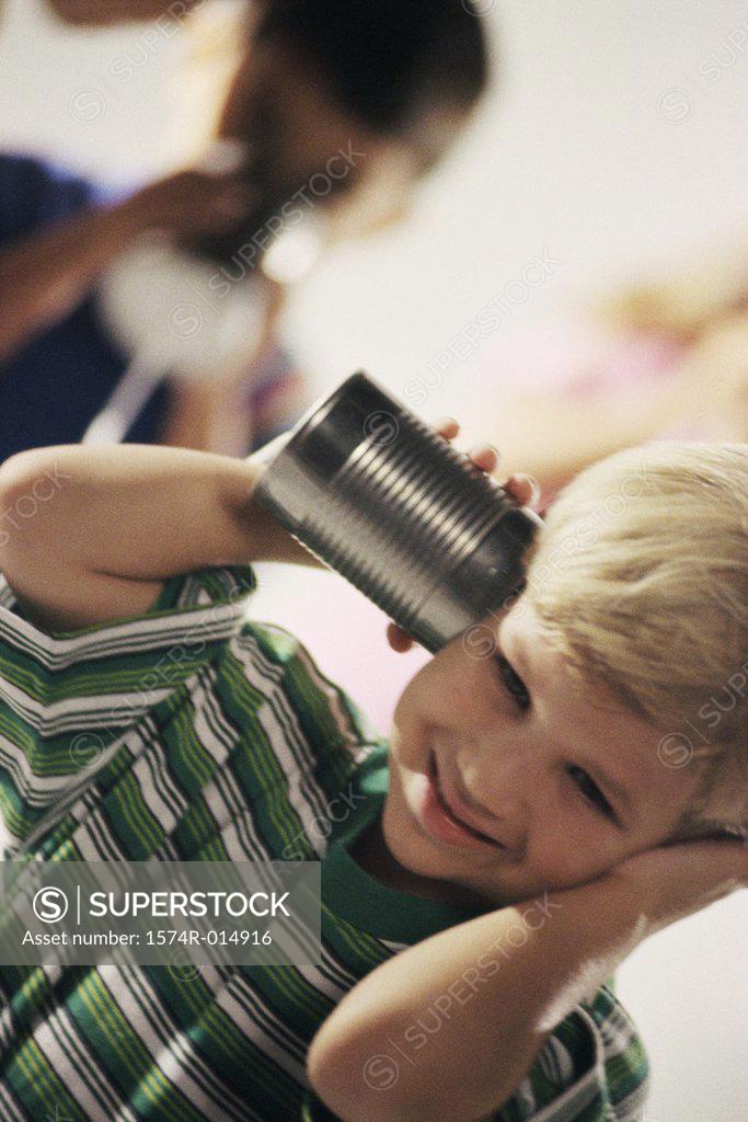 Stock Photo: 1574R-014916 Two boys playing with a tin can phone
