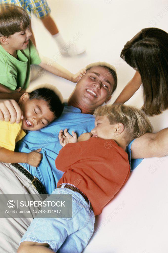 Stock Photo: 1574R-014917 High angle view of a young man playing with children