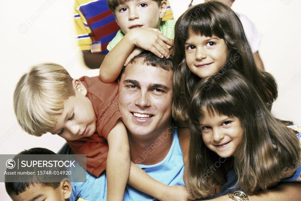 Stock Photo: 1574R-014920 Portrait of a young man posing with children