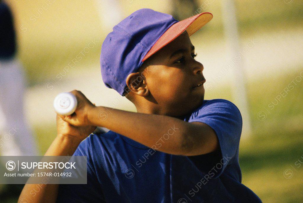 Stock Photo: 1574R-014932 Close-up of a baseball player swinging a baseball bat