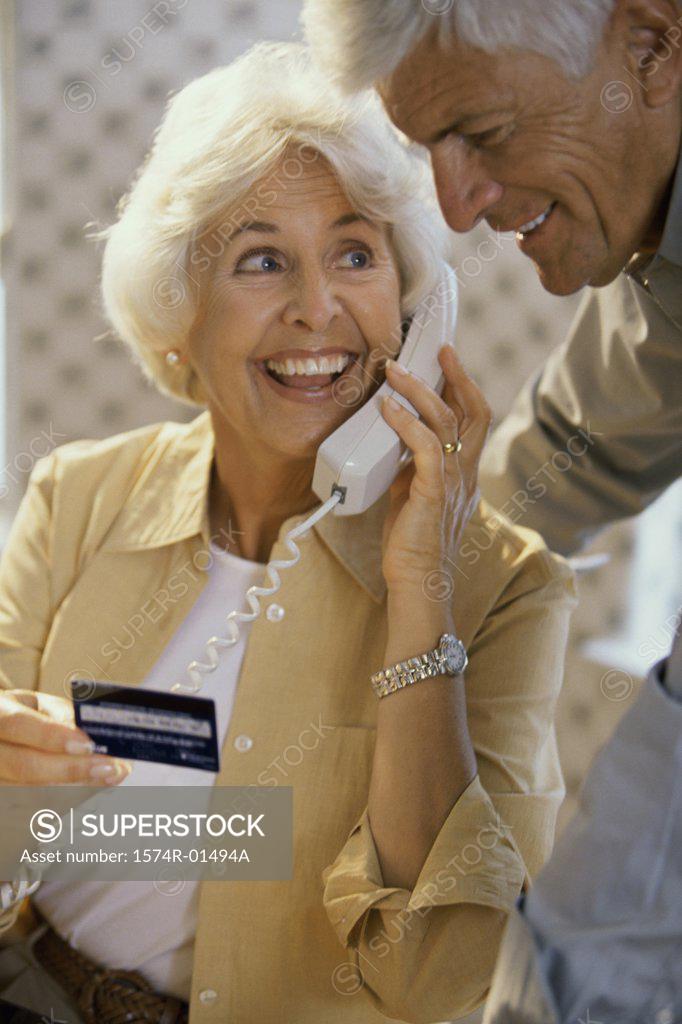 Stock Photo: 1574R-01494A Senior couple holding a credit card