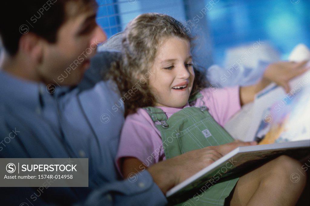 Stock Photo: 1574R-014958 Close-up of a father teaching his daughter