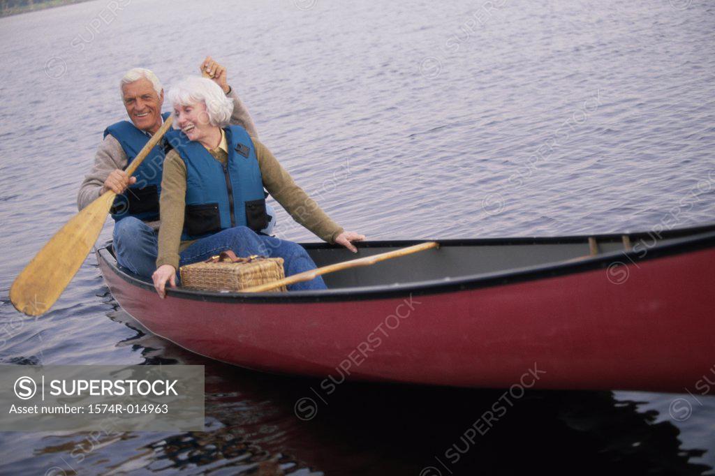 Stock Photo: 1574R-014963 Senior couple rowing a boat
