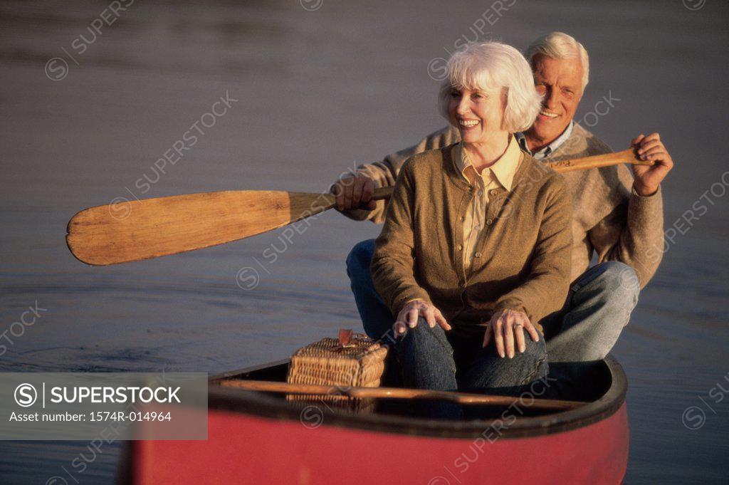 Stock Photo: 1574R-014964 Senior couple rowing a boat