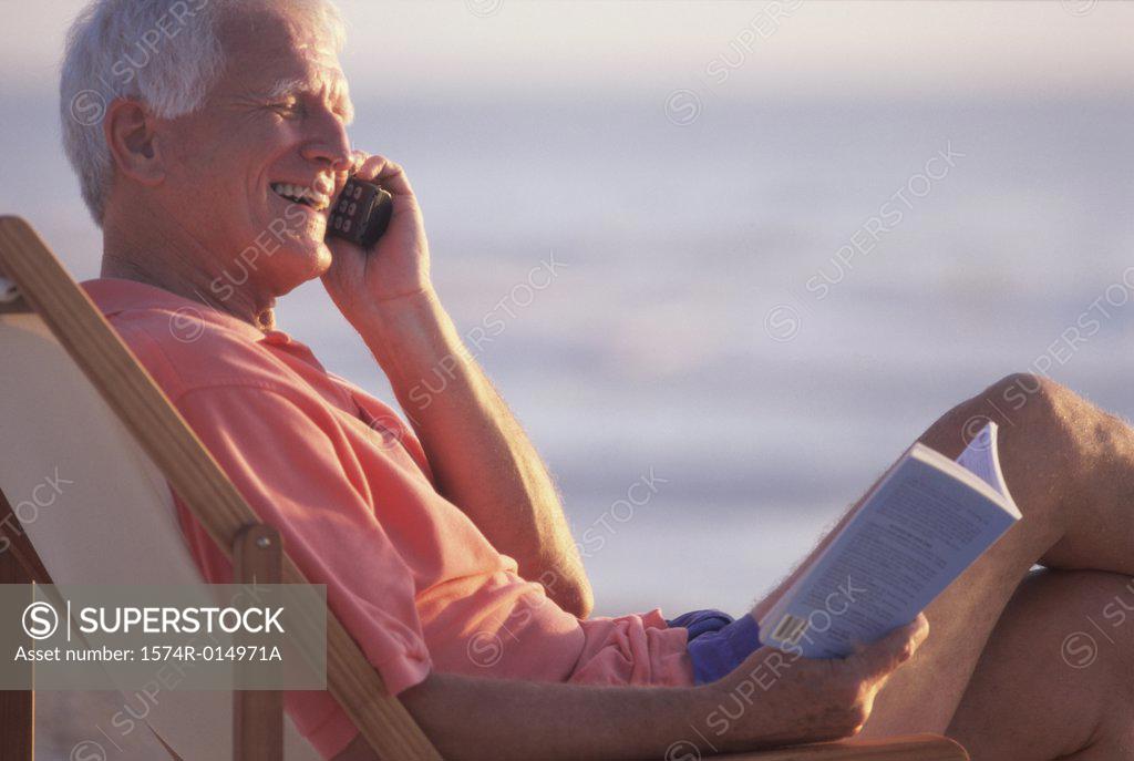 Stock Photo: 1574R-014971A Side profile of a senior man talking on a mobile phone
