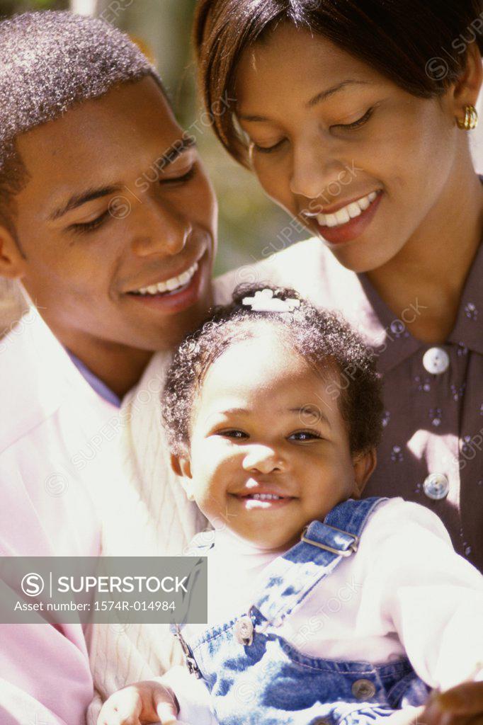 Stock Photo: 1574R-014984 Close-up of parents and their daughter smiling