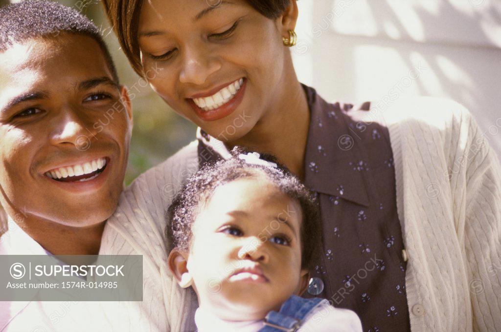 Stock Photo: 1574R-014985 Close-up of parents smiling at their daughter