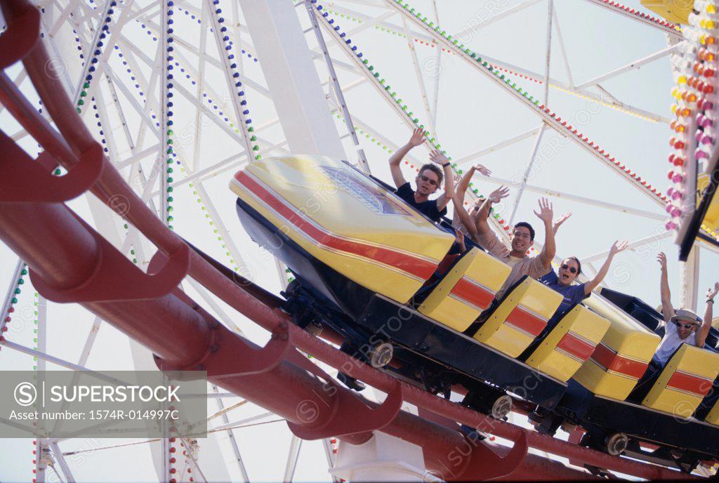 Stock Photo: 1574R-014997C Low angle view of five people on a rollercoaster