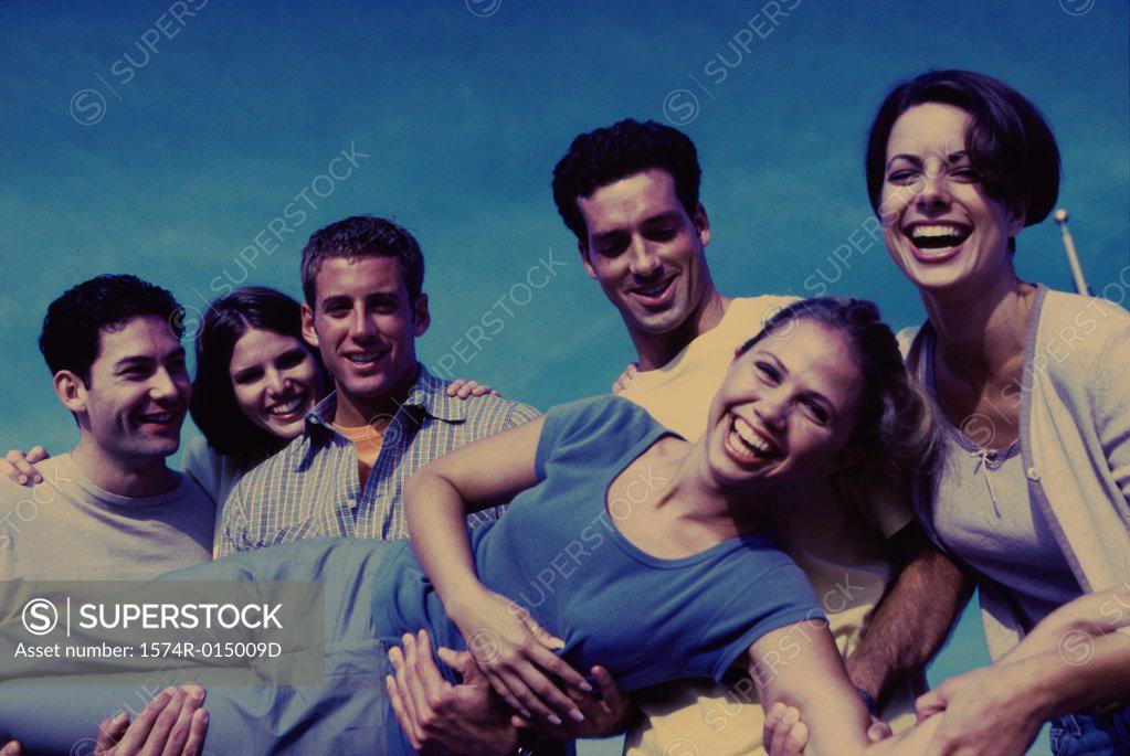 Stock Photo: 1574R-015009D Portrait of a group of young people carrying a young woman