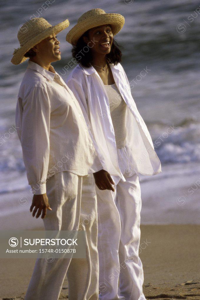 Stock Photo: 1574R-015087B Side profile of a mother standing with her daughter on the beach