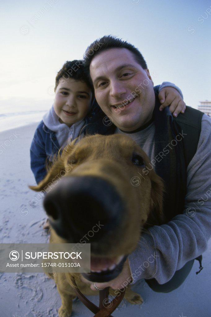 Stock Photo: 1574R-015103A Portrait of a father and son with their dog