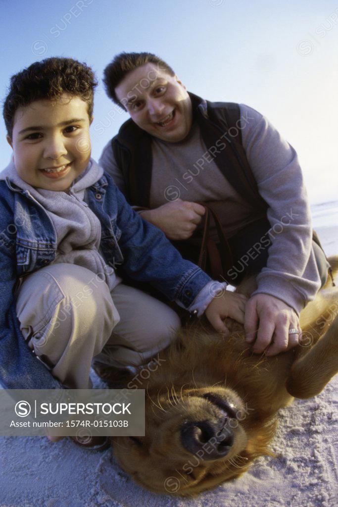 Stock Photo: 1574R-015103B Portrait of a father and son with their dog